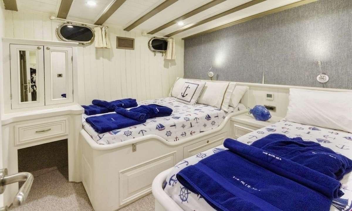 a couple of beds in a room aboard THE BLUE SEA Yacht for Charter