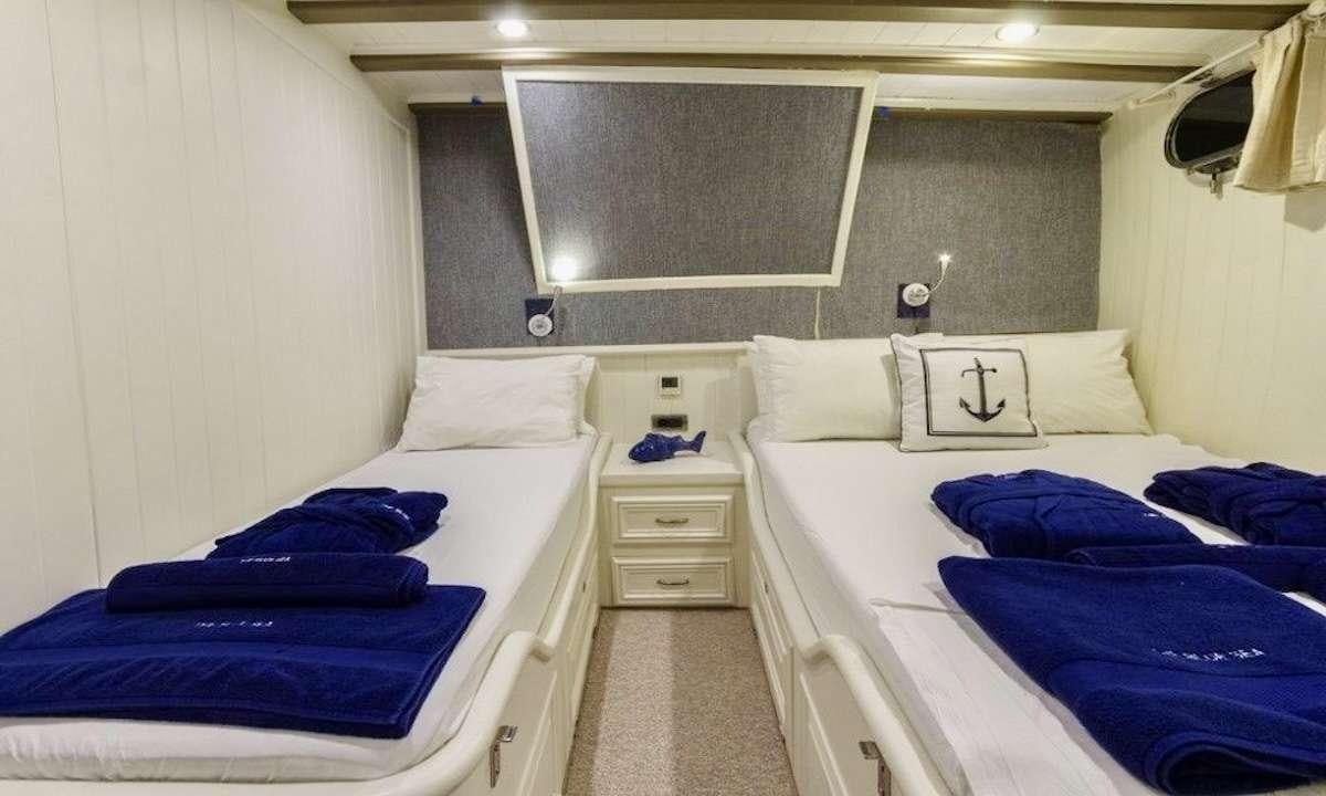 a room with two beds aboard THE BLUE SEA Yacht for Charter