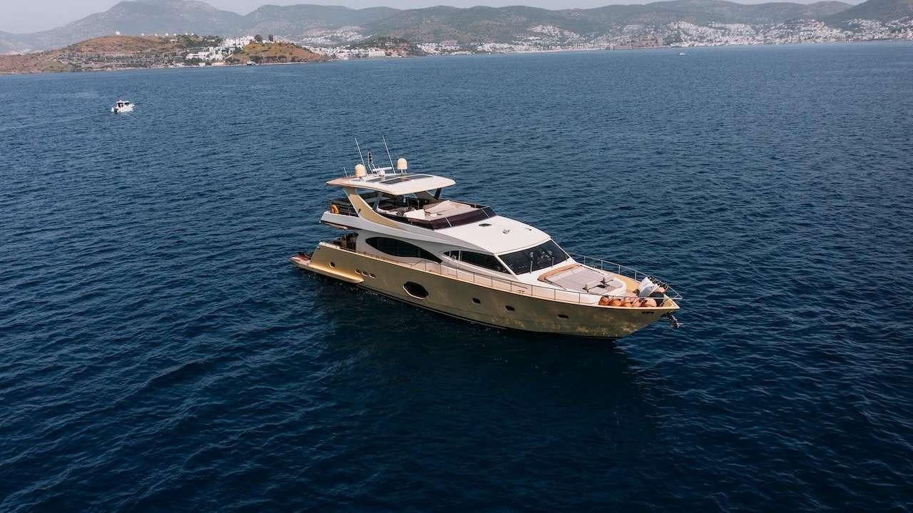 a white boat in the water aboard REIS Yacht for Charter