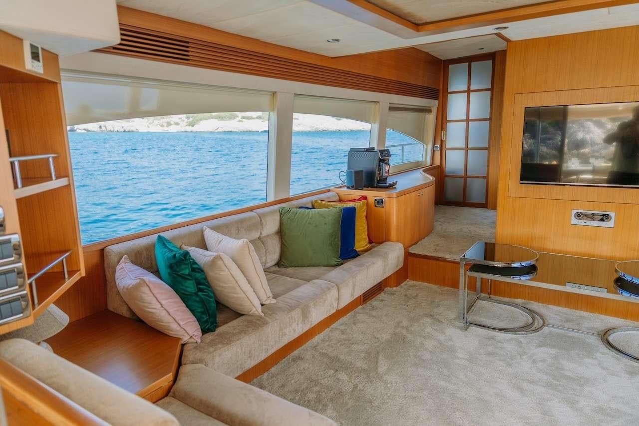 a living room with a large window aboard REIS Yacht for Charter
