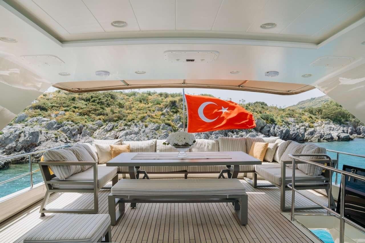 a room with a large pool and a large red flag aboard REIS Yacht for Charter