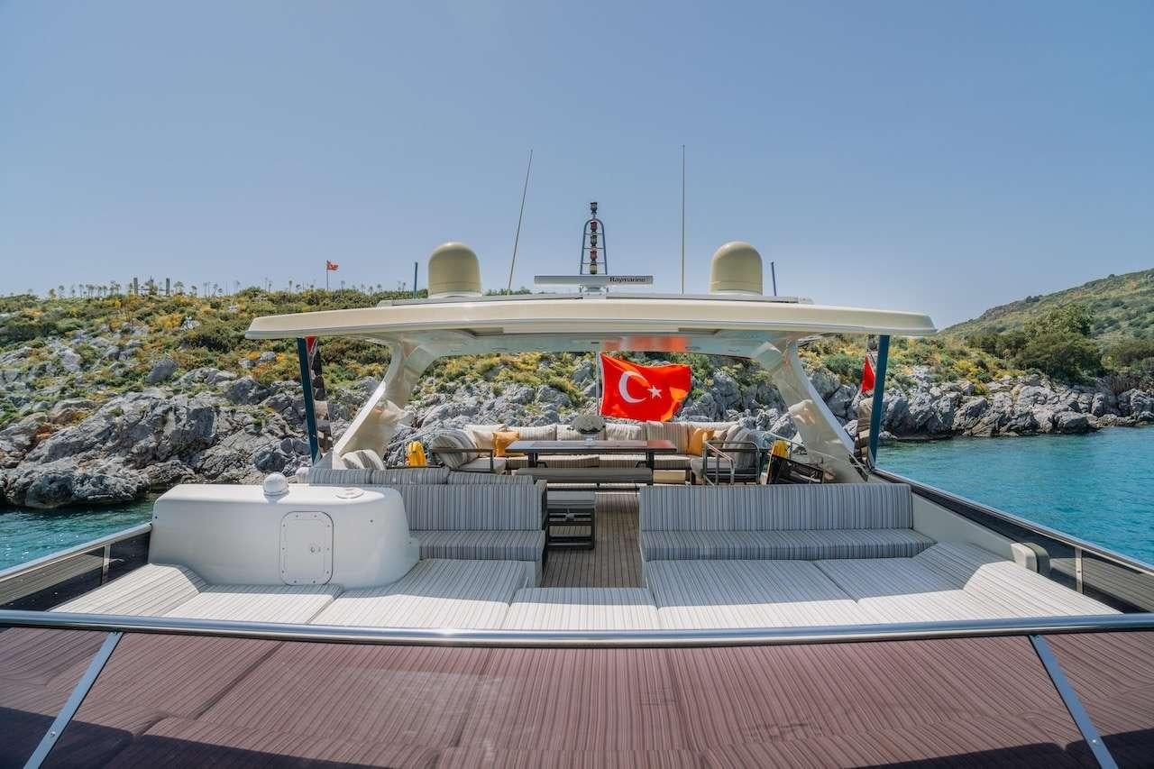 a large white boat on a dock aboard REIS Yacht for Charter