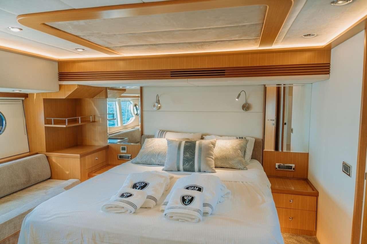 a bed with a white sheet and pillows on it aboard REIS Yacht for Charter
