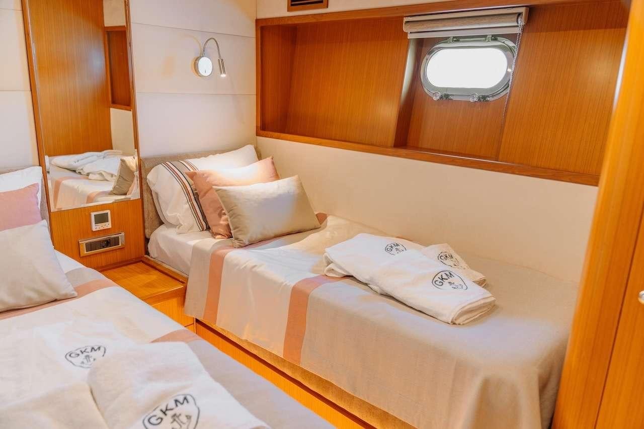a room with two beds aboard REIS Yacht for Charter