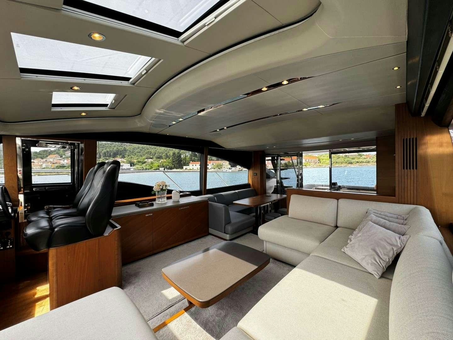 a living room with a couch and a table aboard MALUHIA Yacht for Charter