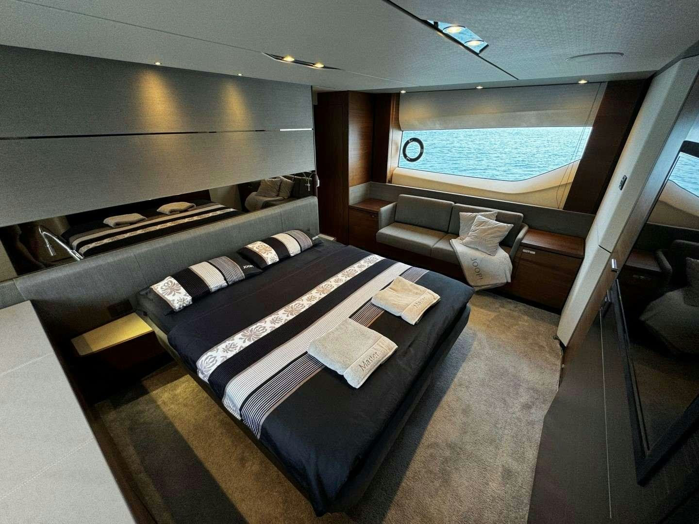 a room with a bed and a couch aboard MALUHIA Yacht for Charter