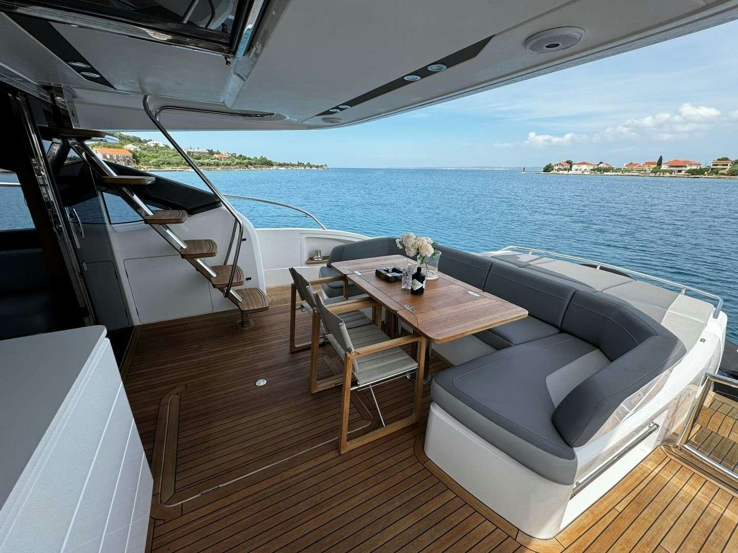 a room with a table and chairs aboard MALUHIA Yacht for Charter