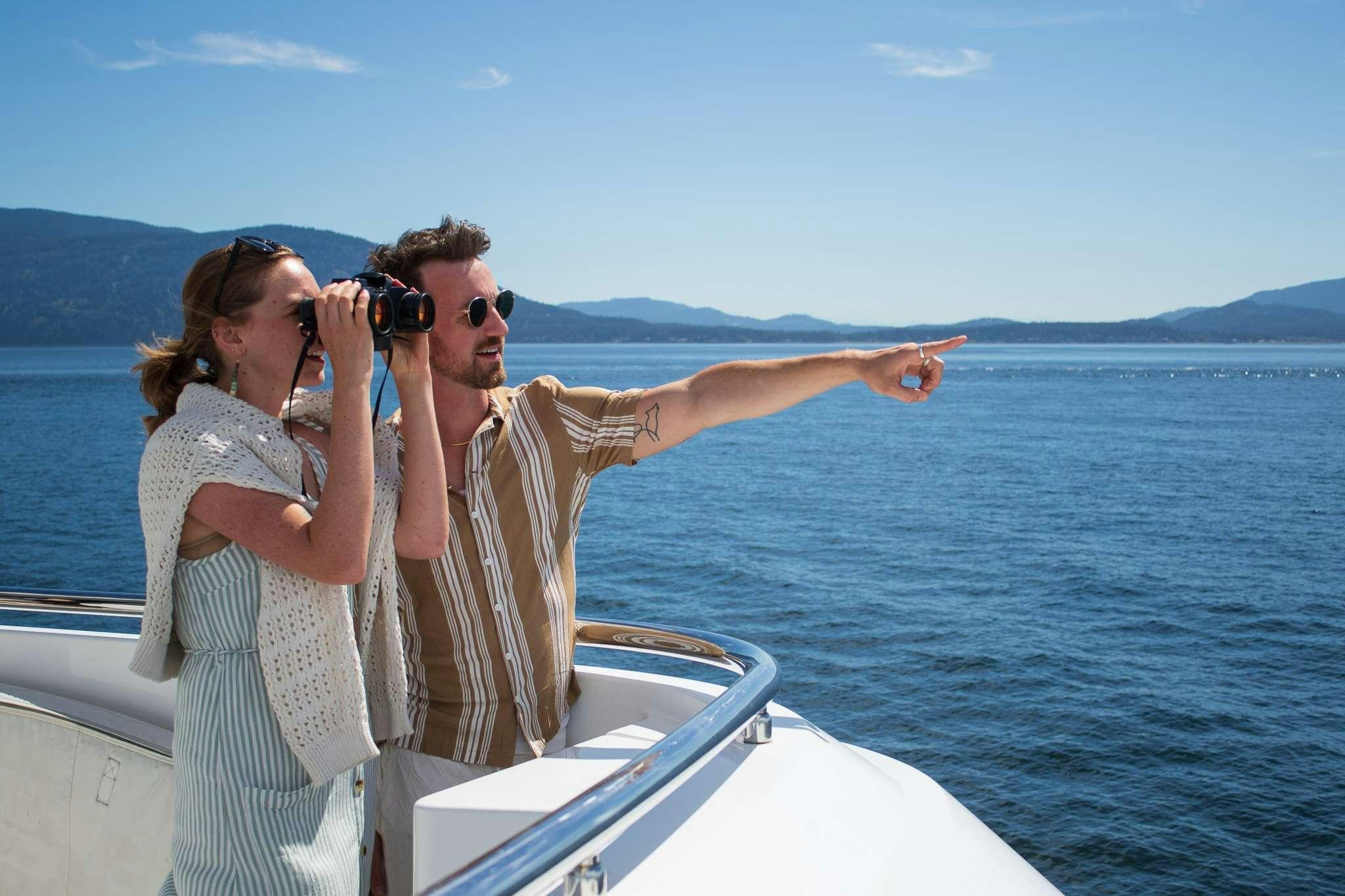 a man and woman taking a picture on a boat aboard SERENDIPITY Yacht for Charter