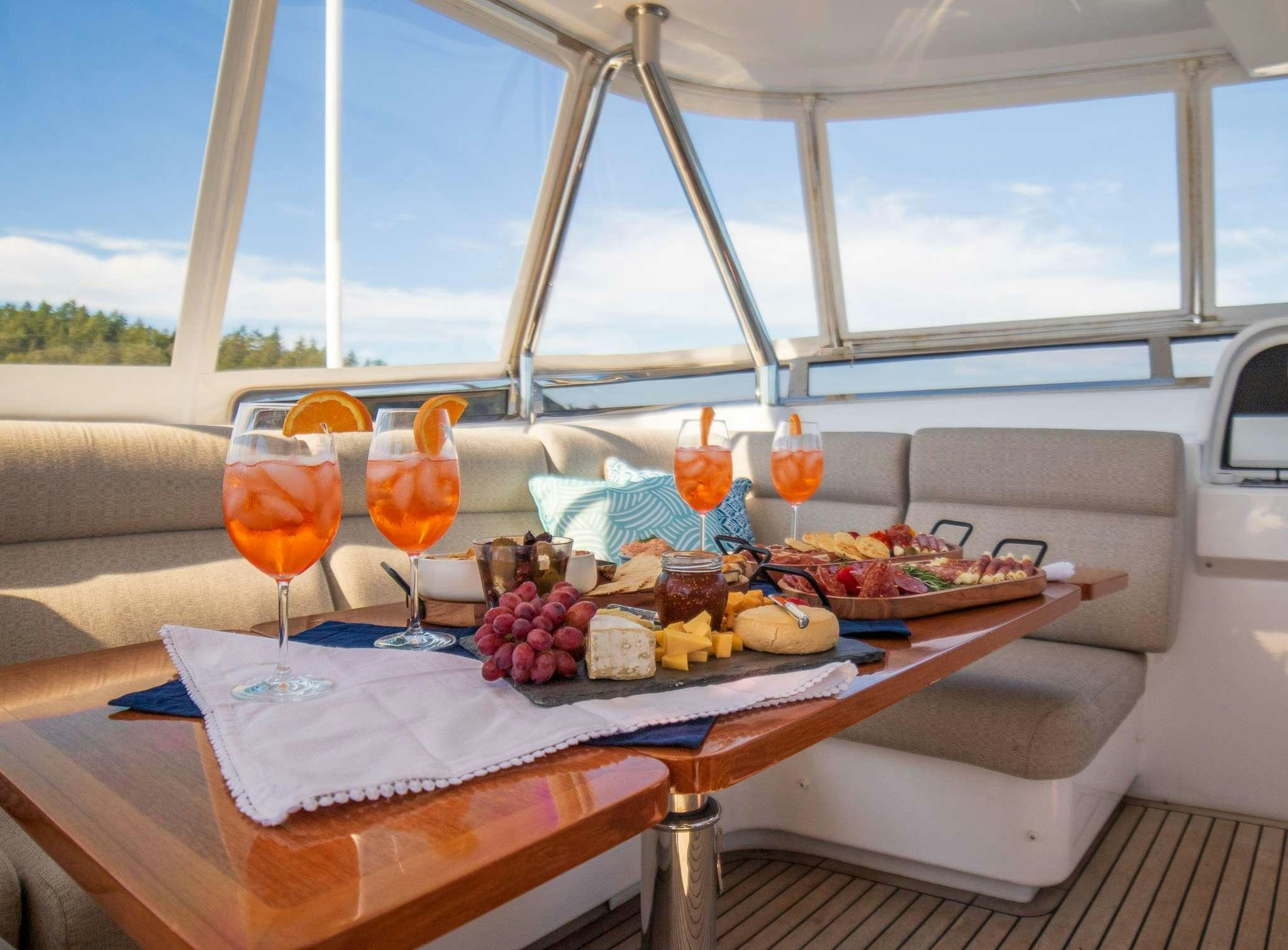 a table with food and drinks on it aboard SERENDIPITY Yacht for Charter