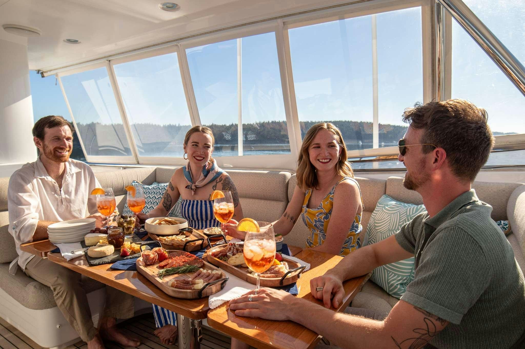 a group of people eating at a table aboard SERENDIPITY Yacht for Charter