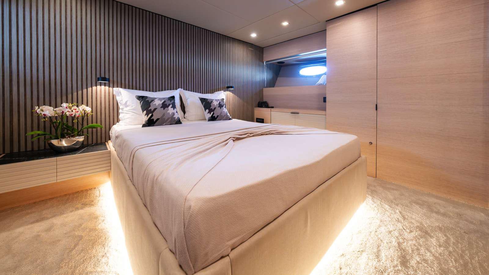 a room with a bed and a desk aboard ALFA Yacht for Charter