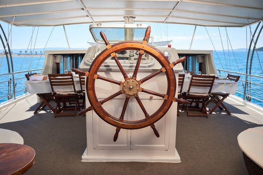 a large clock on a stand aboard NAUTILUS Yacht for Charter
