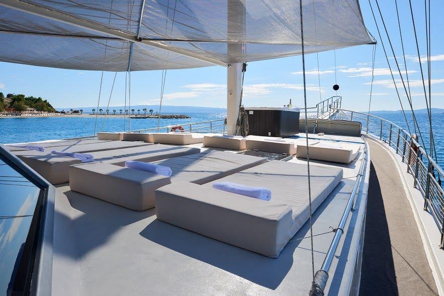 a deck with a large white boat on it aboard NAUTILUS Yacht for Charter