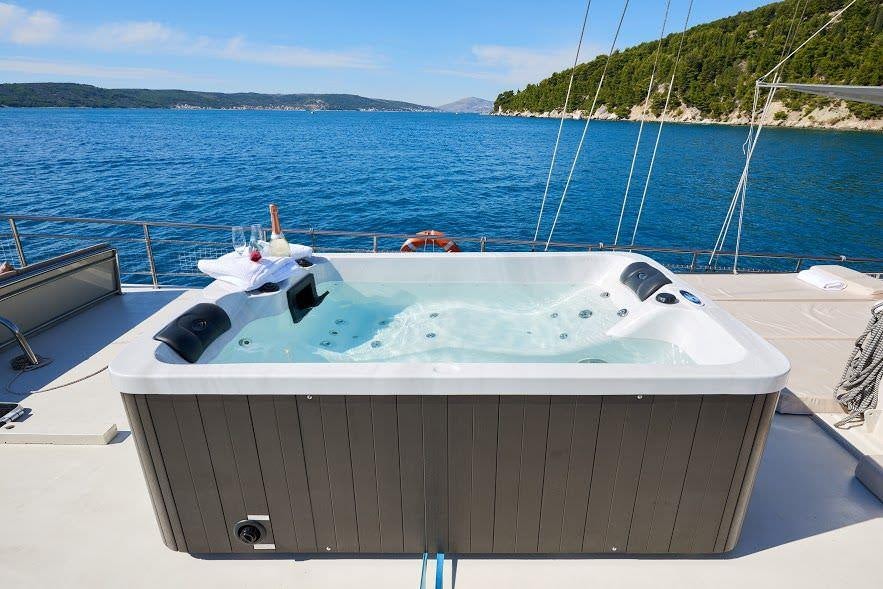 a white boat on a blue water aboard NAUTILUS Yacht for Charter