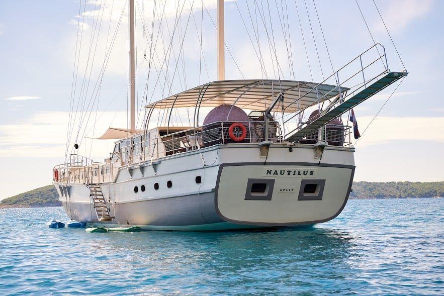 a large white boat in the water aboard NAUTILUS Yacht for Charter