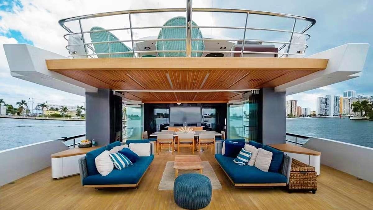 a modern living room with a large swimming pool aboard CYRA Yacht for Charter