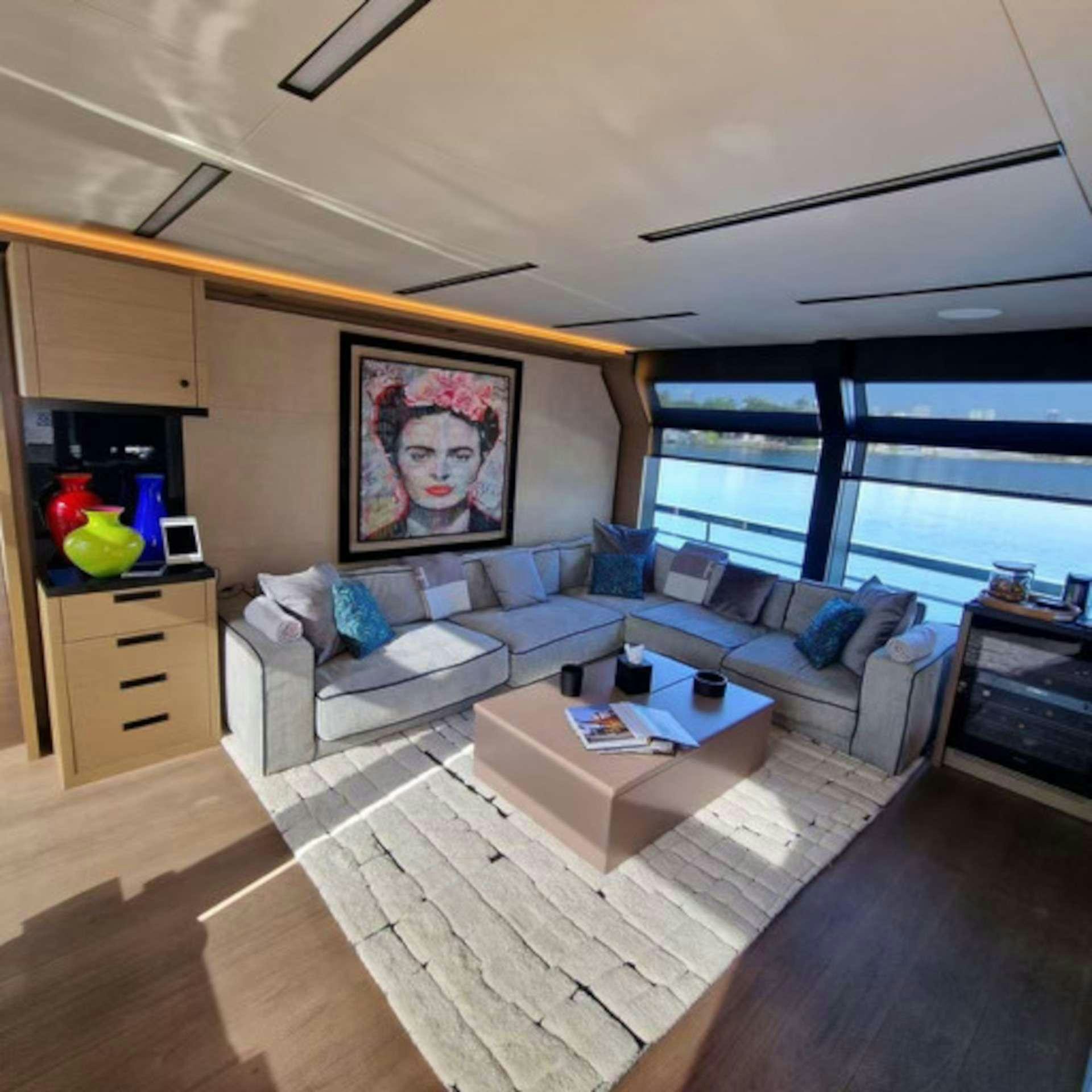 a living room with a large window aboard CYRA Yacht for Charter