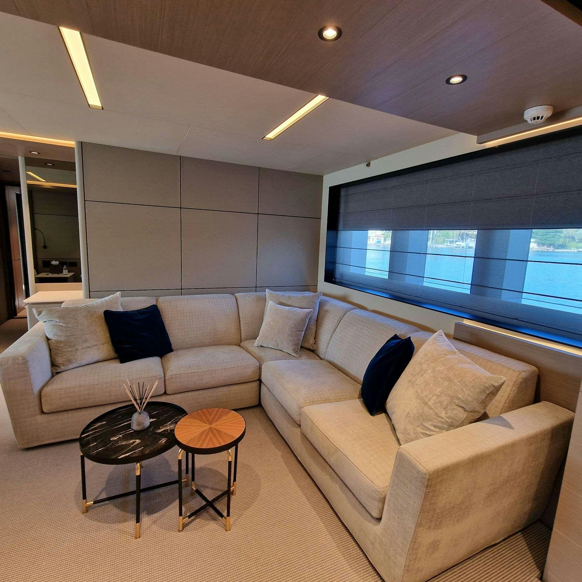a living room with a large window aboard CYRA Yacht for Charter