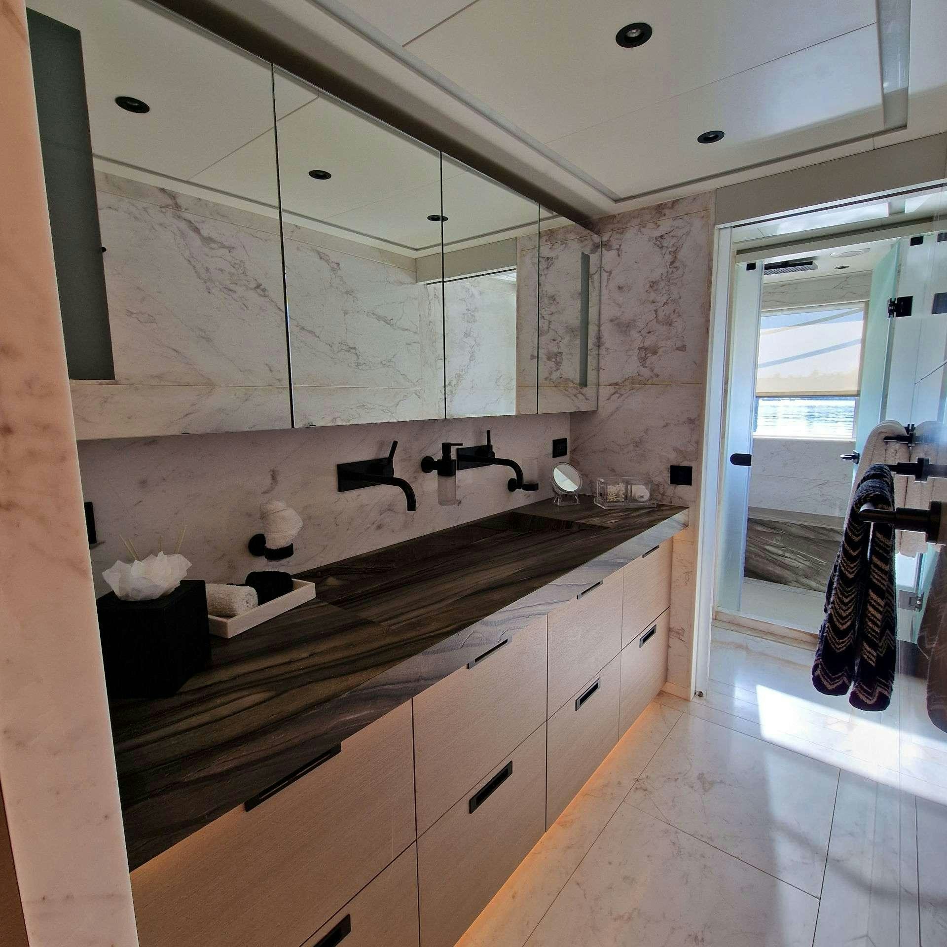 a person standing in a kitchen aboard CYRA Yacht for Charter