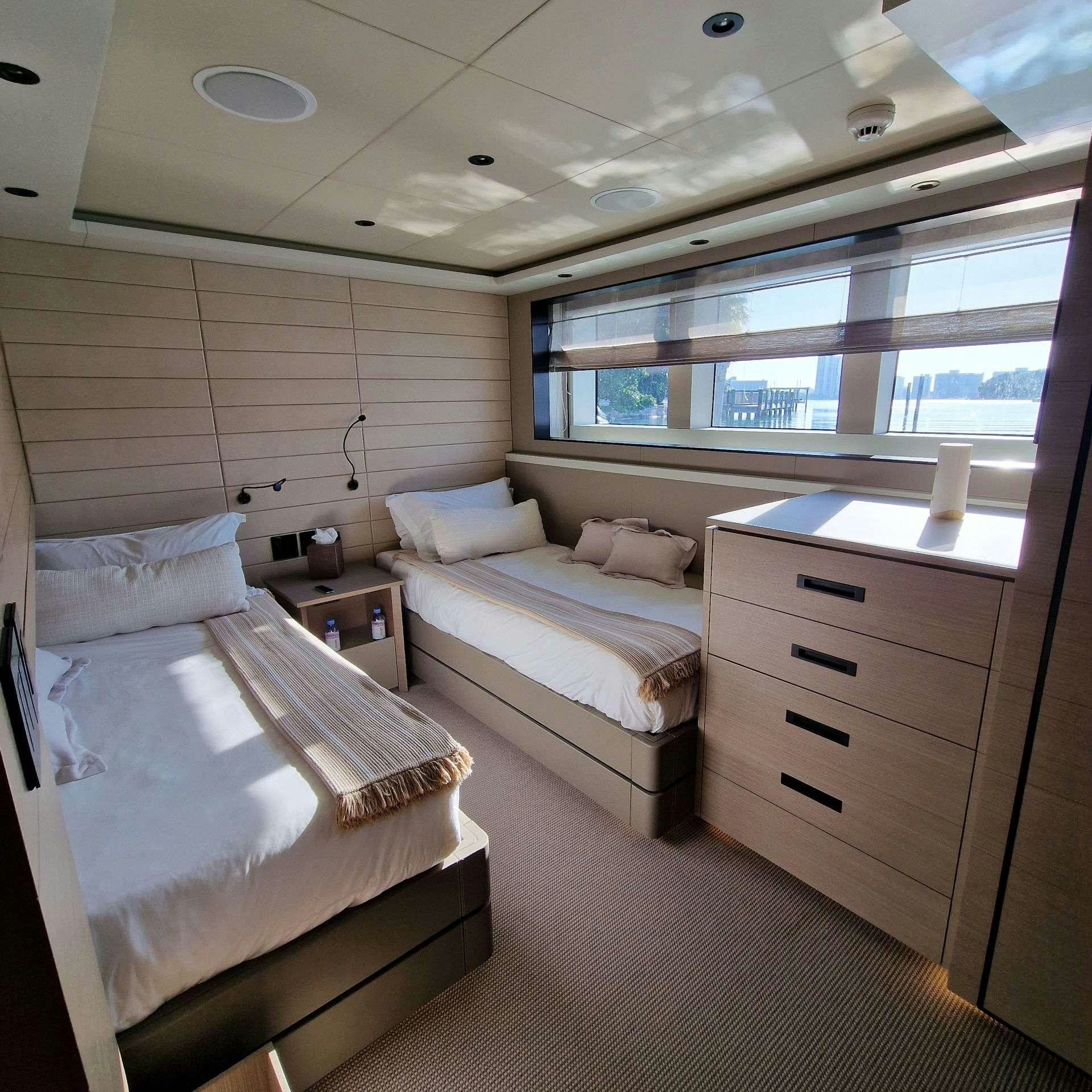 a room with a bed and a window aboard CYRA Yacht for Charter