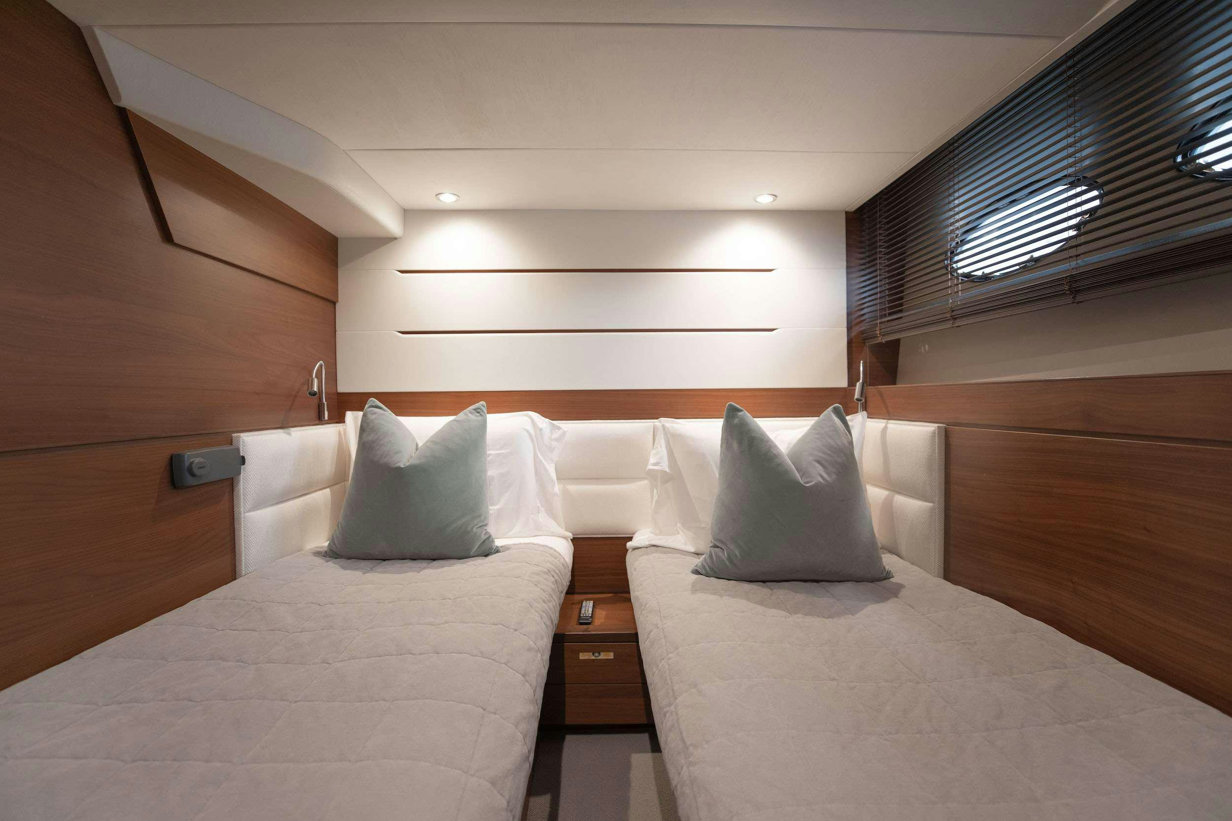 a room with a bed and a window aboard SABLE Yacht for Charter