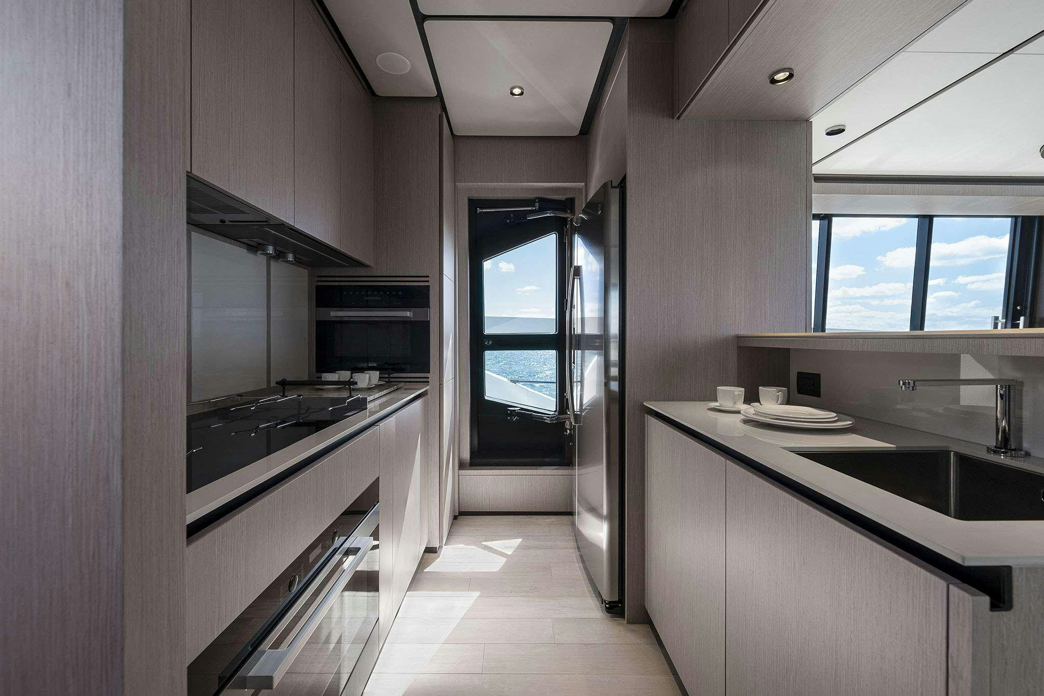 a kitchen with a large window aboard 5 PALMS Yacht for Charter