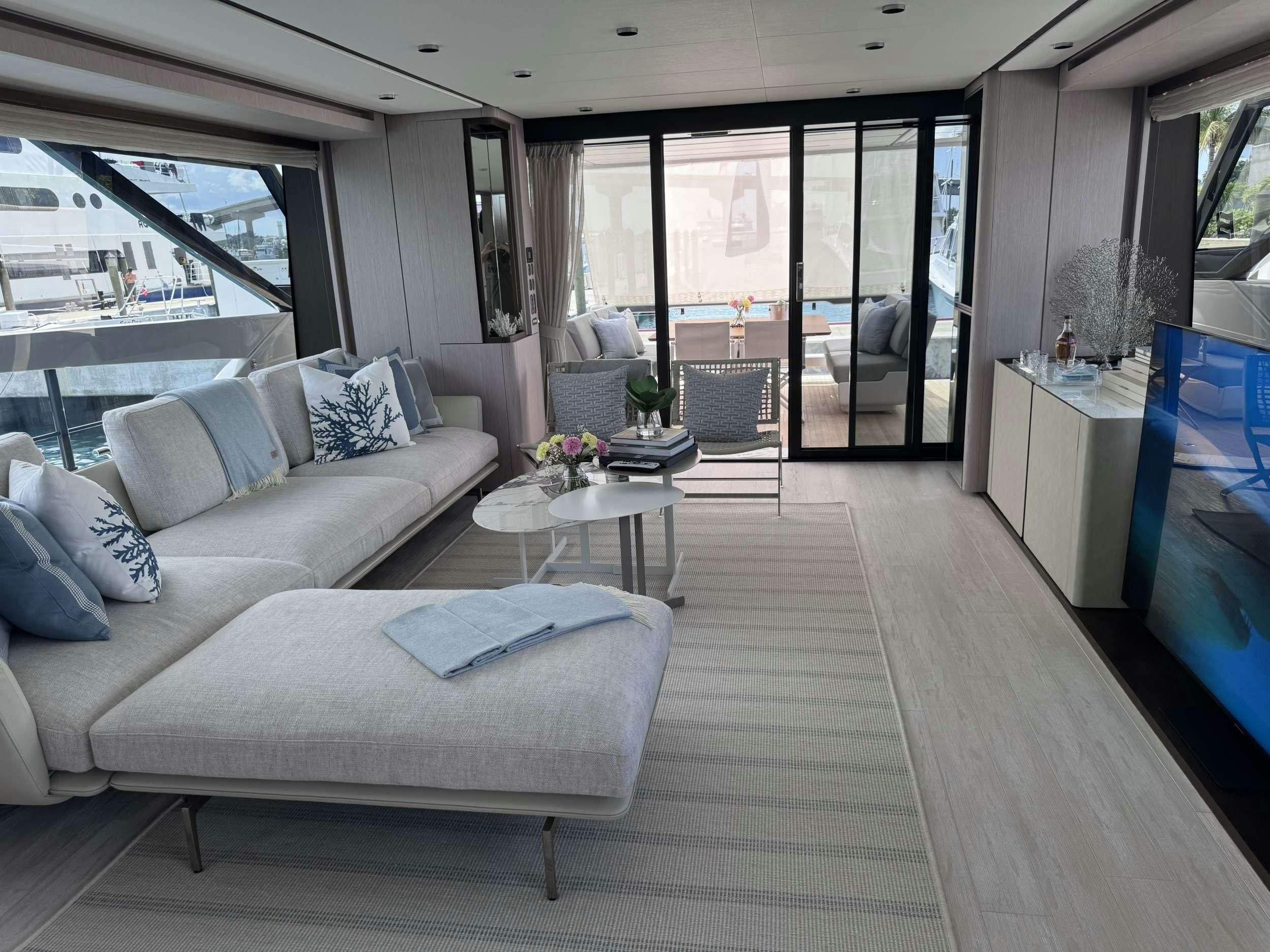 a living room with a large window aboard 5 PALMS Yacht for Charter