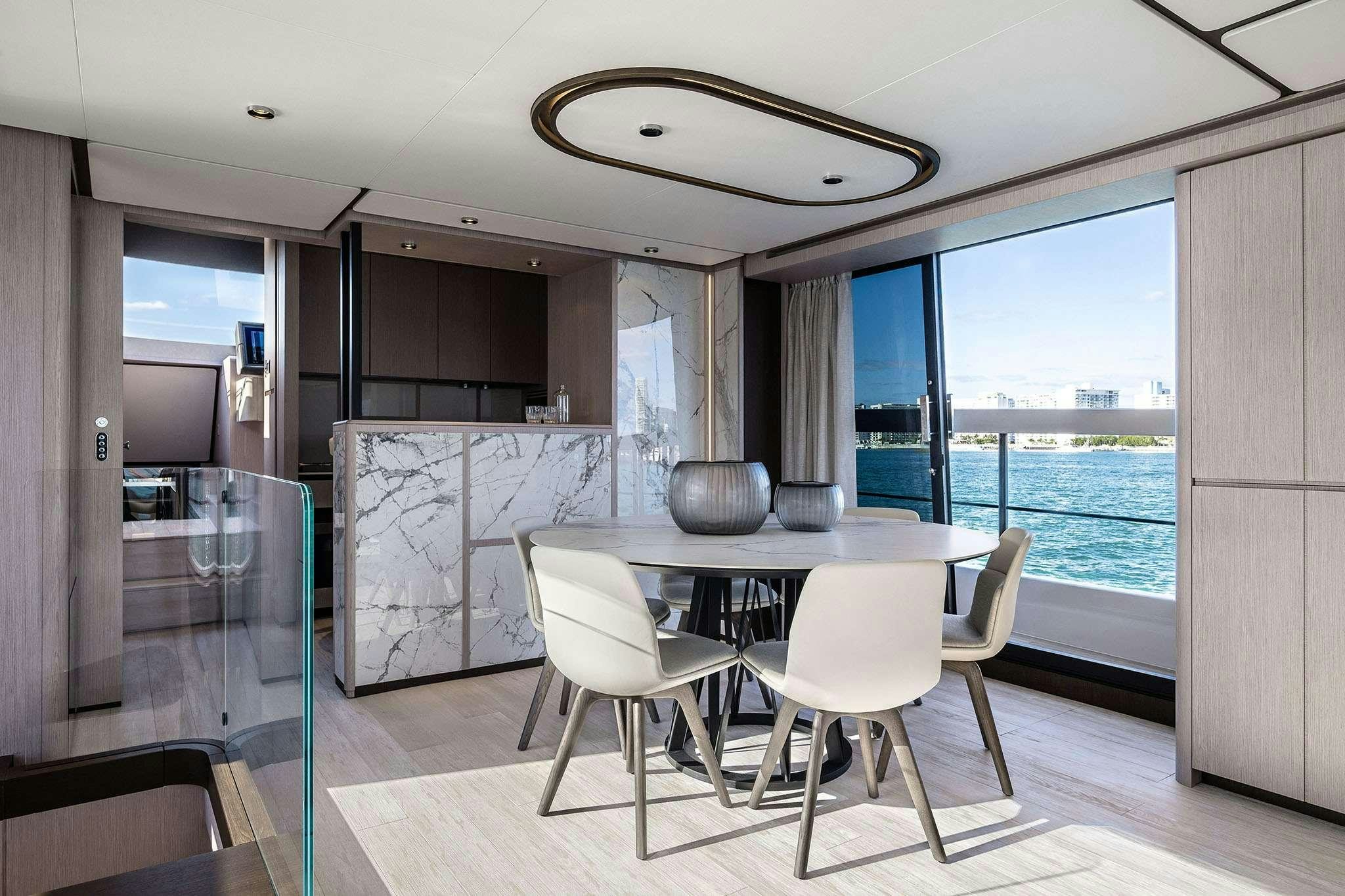 a large kitchen with a table and chairs aboard 5 PALMS Yacht for Charter