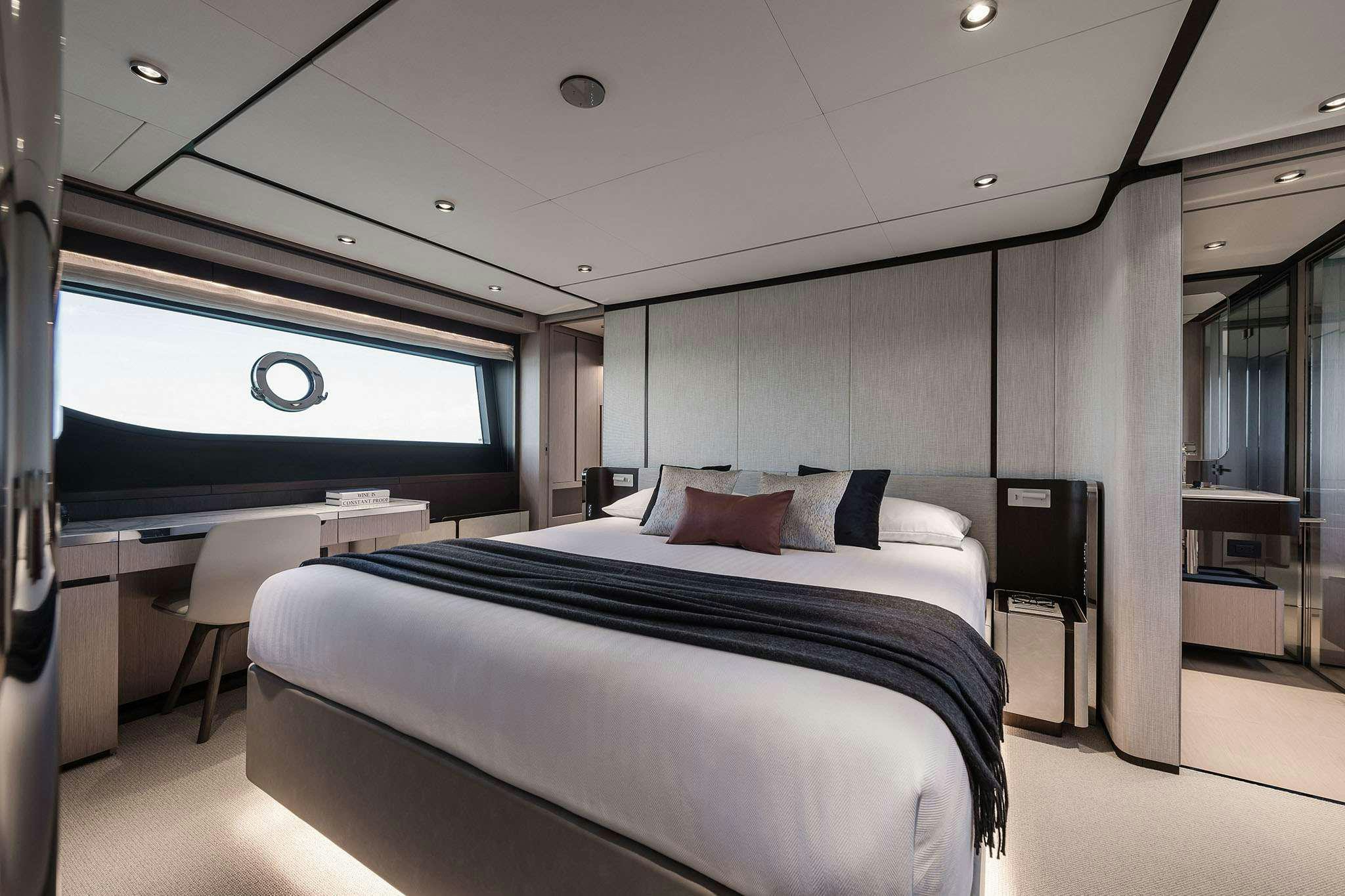 a room with a bed and a large window aboard 5 PALMS Yacht for Charter