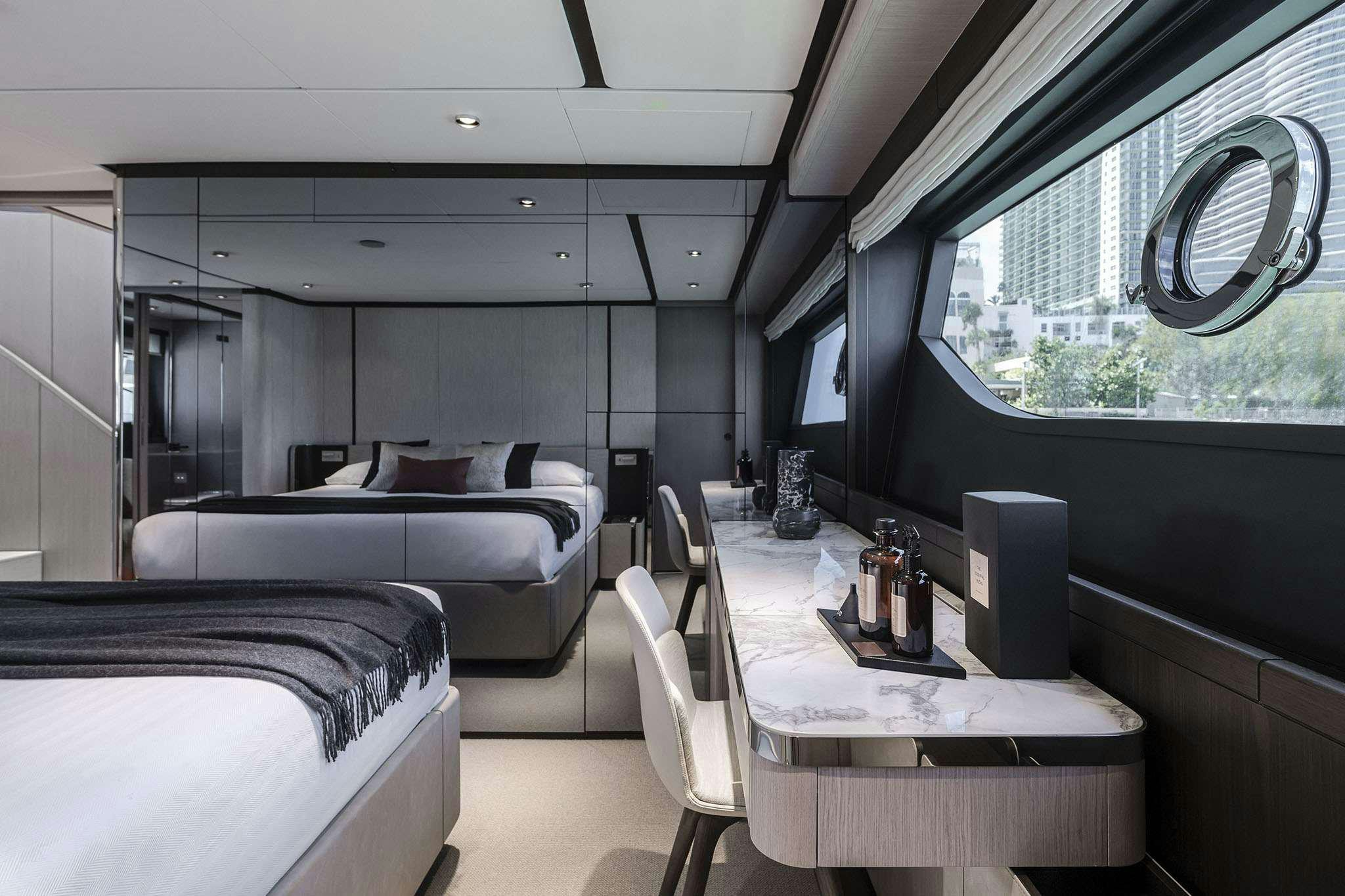 a room with a bed and a desk aboard 5 PALMS Yacht for Charter