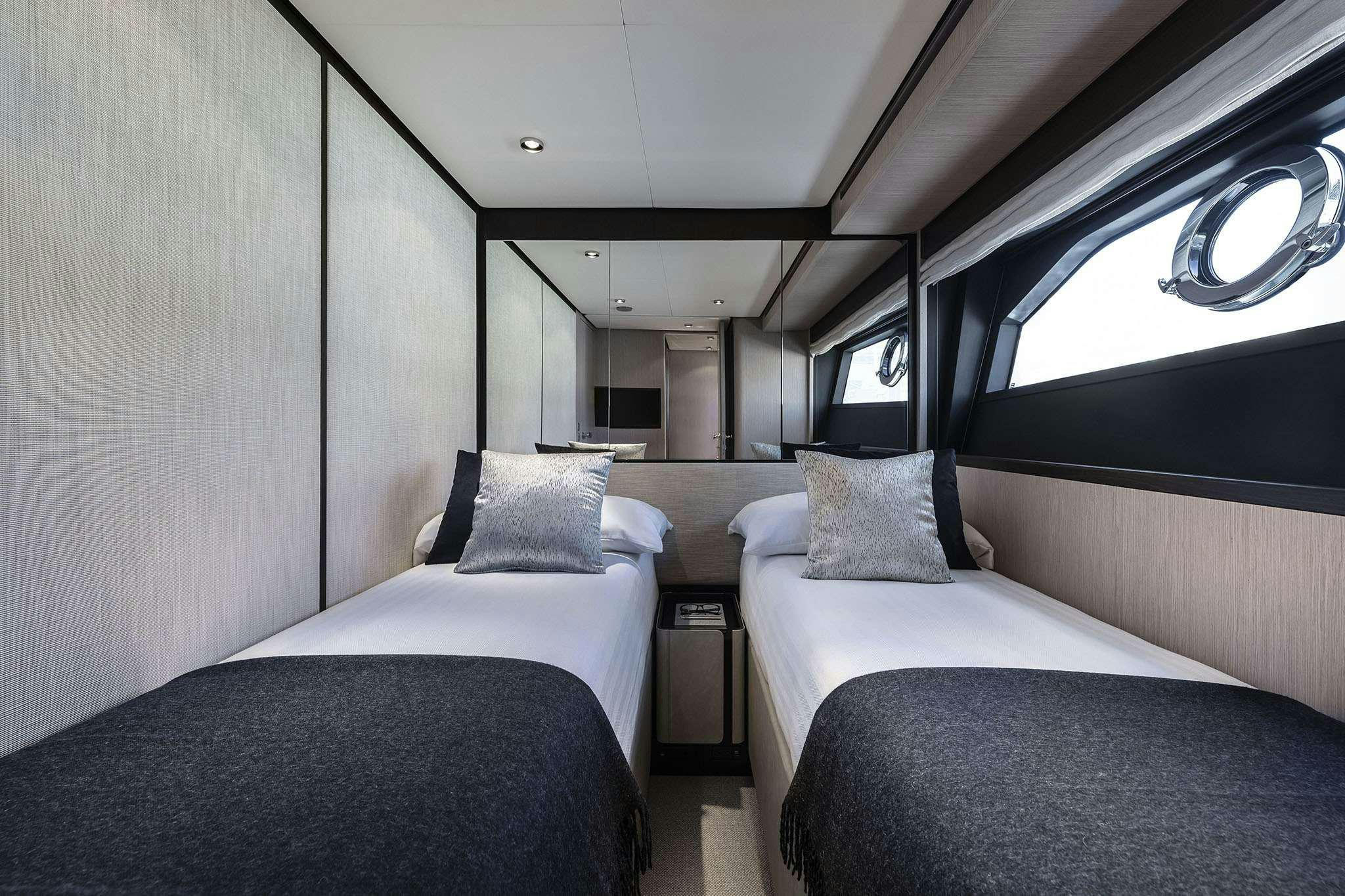 a couple of beds in a room aboard 5 PALMS Yacht for Charter