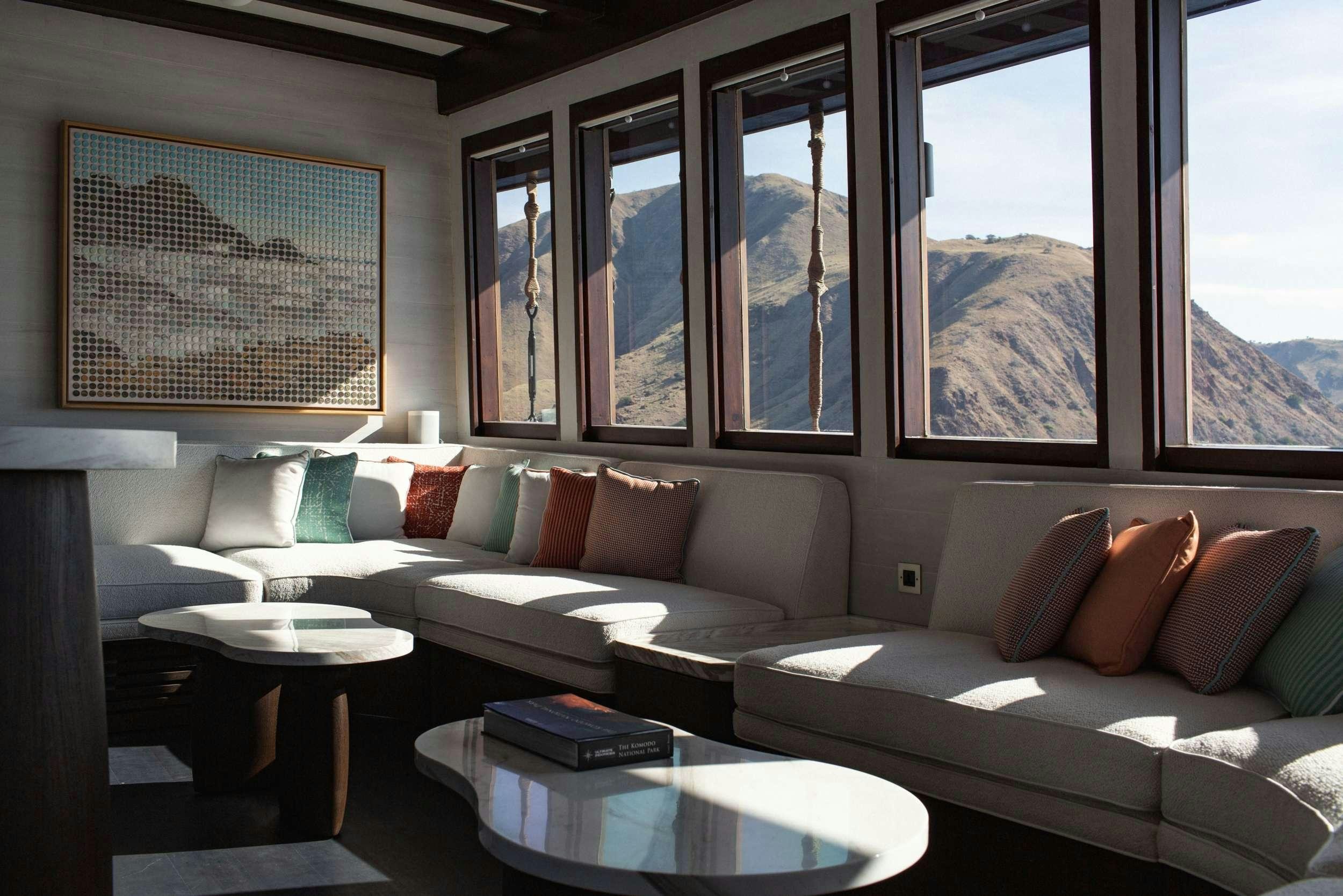 a living room with a couch and a table aboard VELA Yacht for Charter