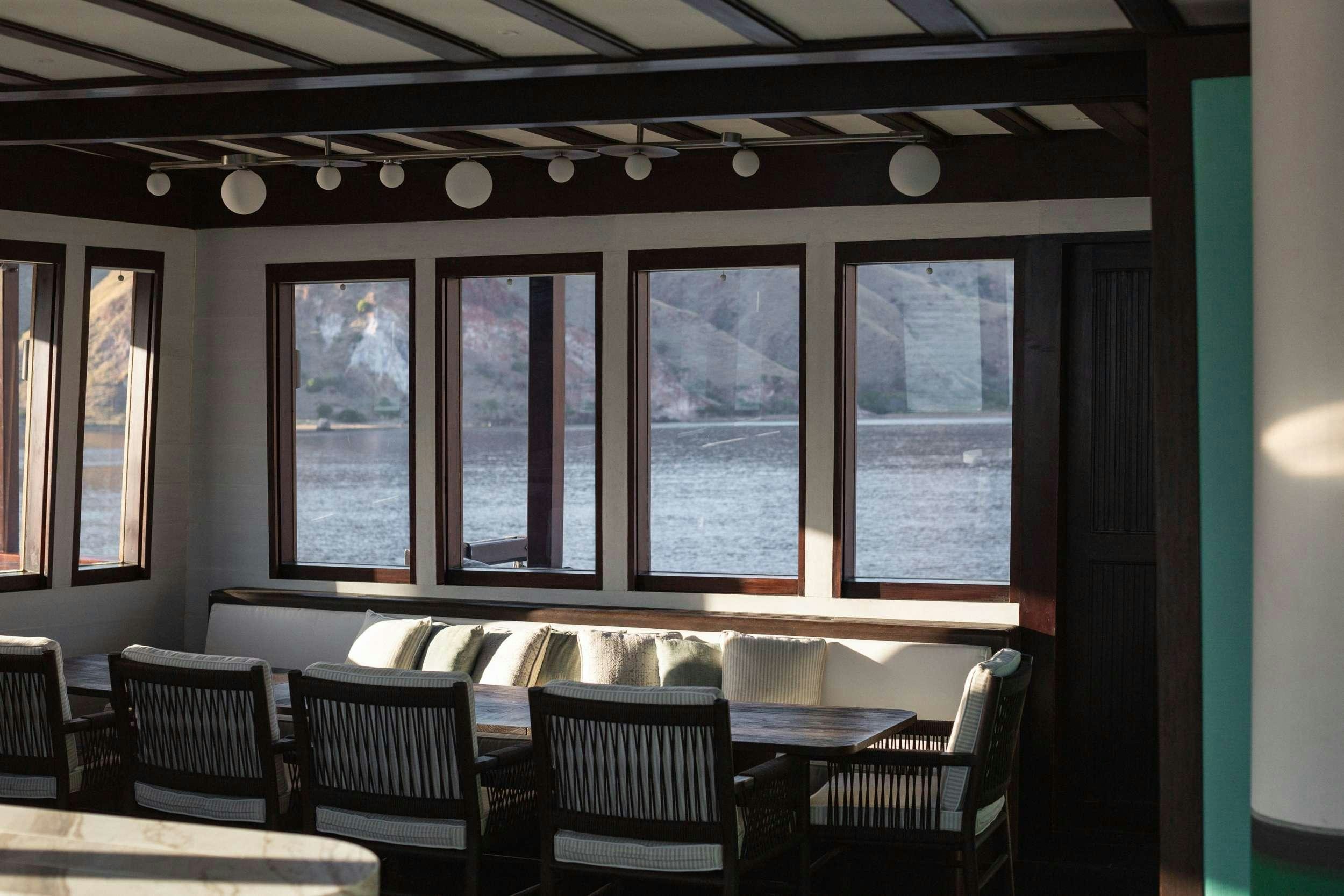 a room with a table and chairs aboard VELA Yacht for Charter