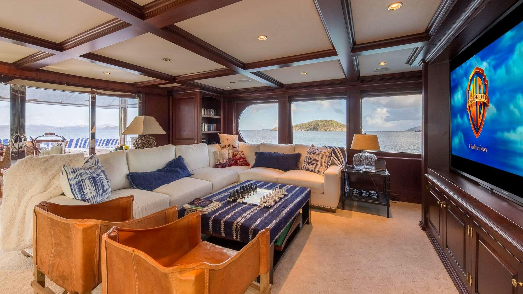 a large living room with a large screen aboard KING OF FUN Yacht for Charter