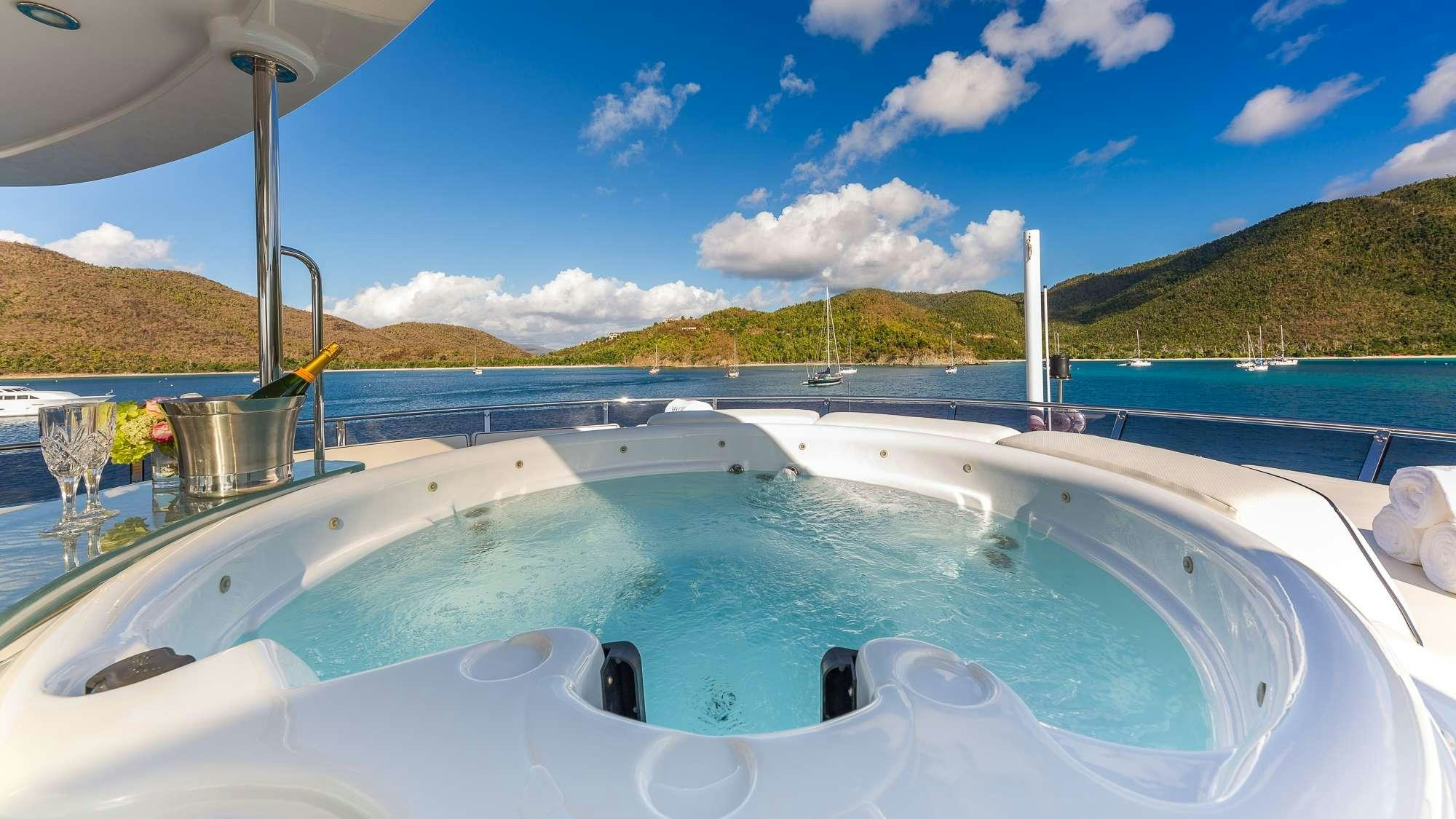a swimming pool with a view of mountains and water aboard KING OF FUN Yacht for Charter