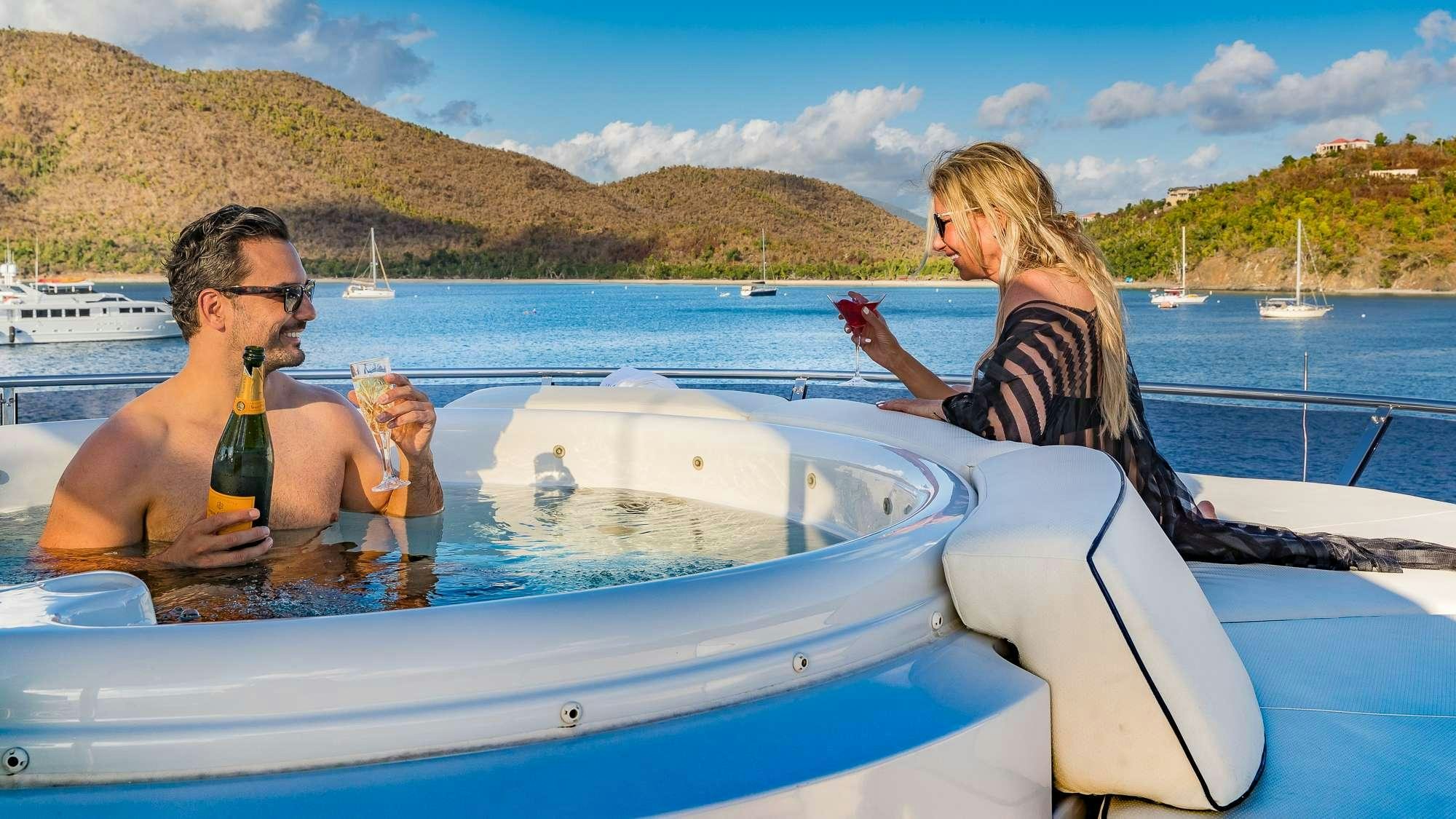 a man and woman on a boat aboard KING OF FUN Yacht for Charter