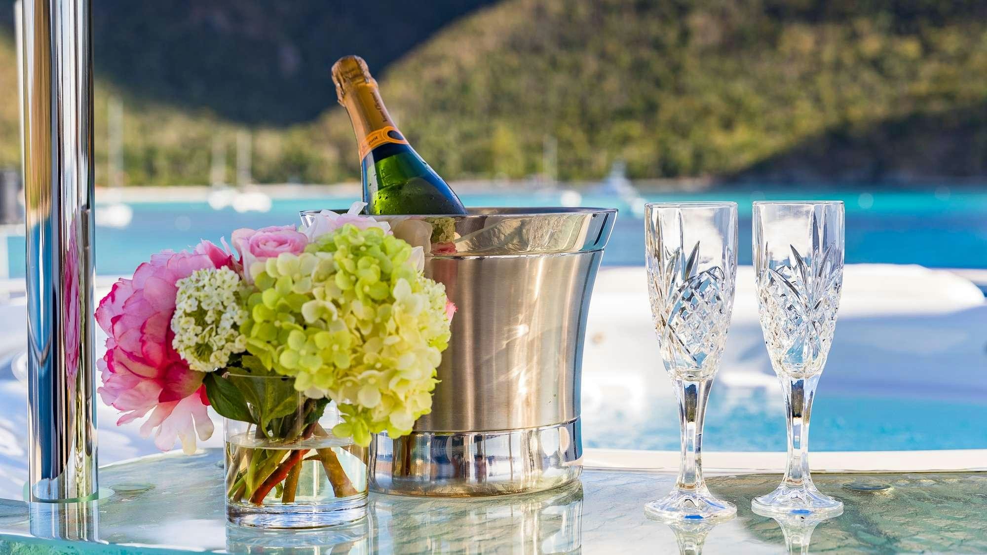 a group of glasses with flowers in them aboard KING OF FUN Yacht for Charter