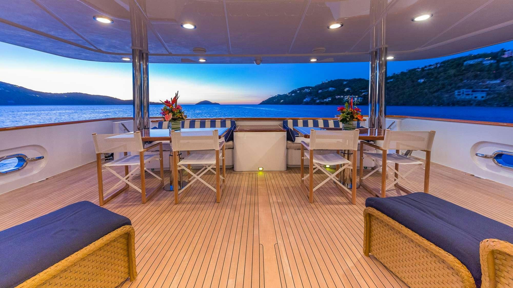 a room with tables and chairs aboard KING OF FUN Yacht for Charter