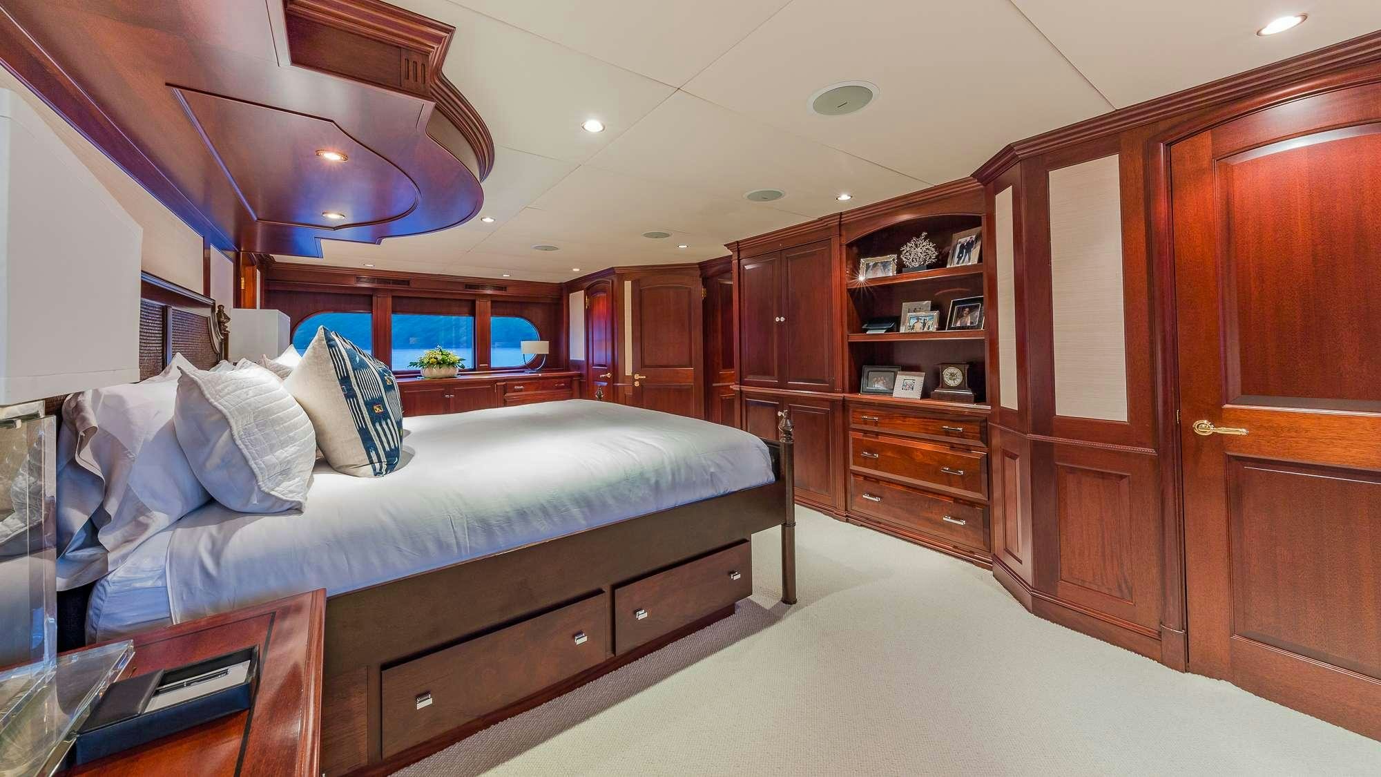a bedroom with a bed and a desk aboard KING OF FUN Yacht for Charter