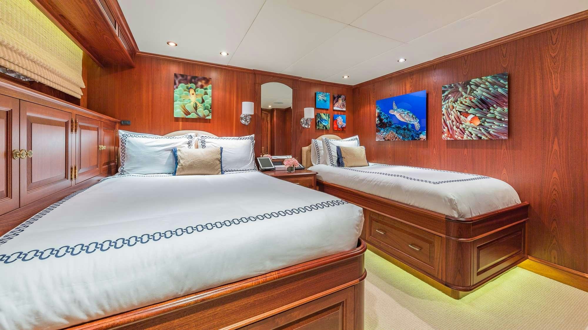 a room with two beds aboard KING OF FUN Yacht for Charter