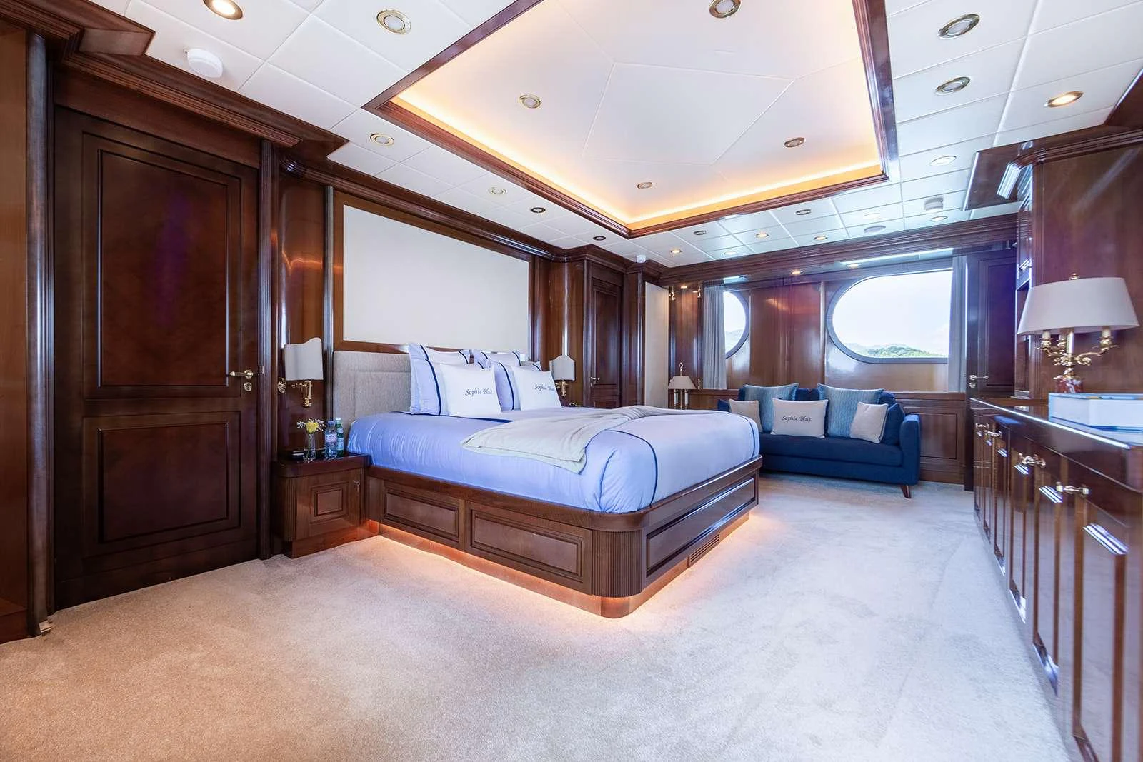 a large bedroom with a bed and a couch aboard SOPHIE BLUE Yacht for Charter