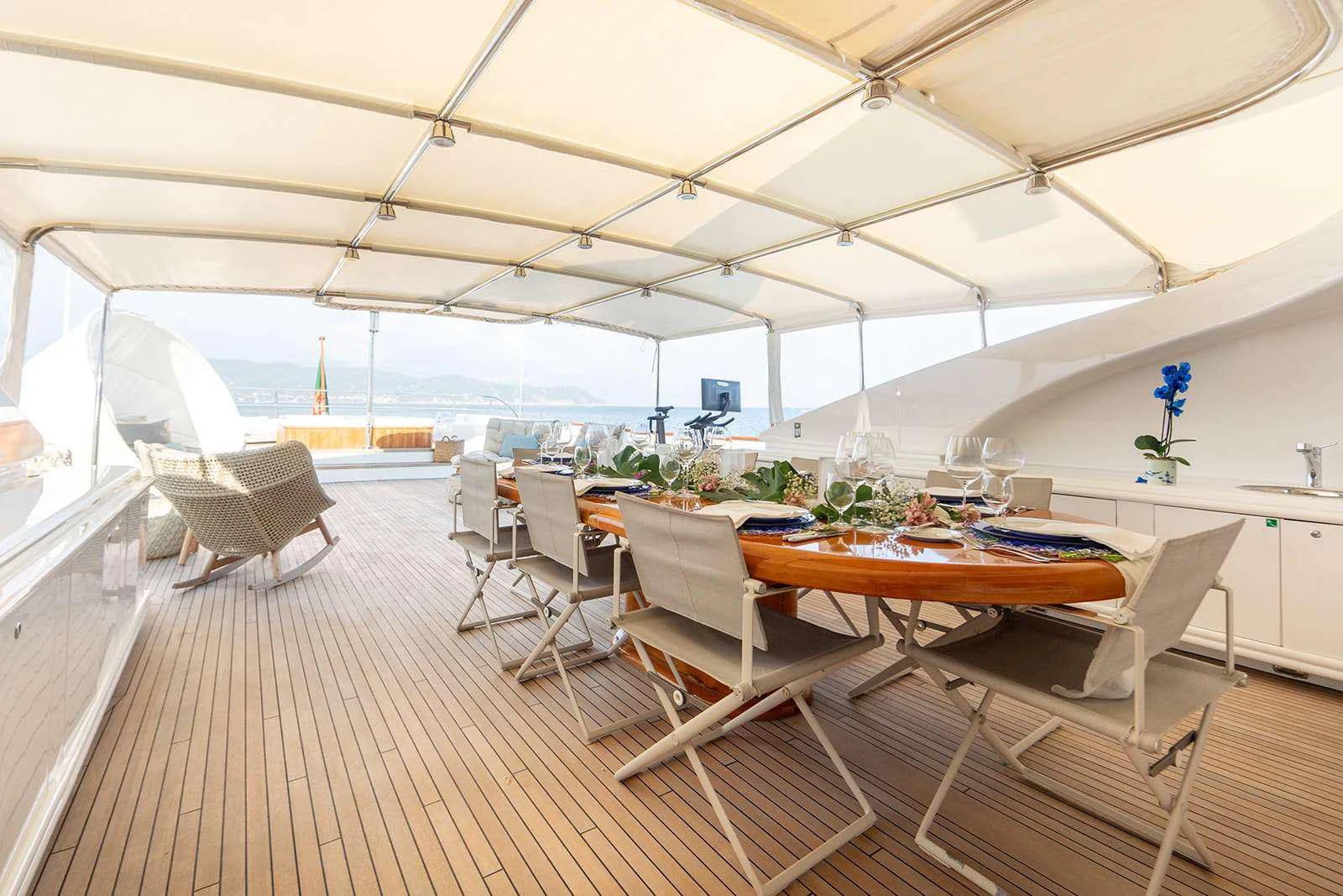 a room with tables and chairs aboard SOPHIE BLUE Yacht for Charter