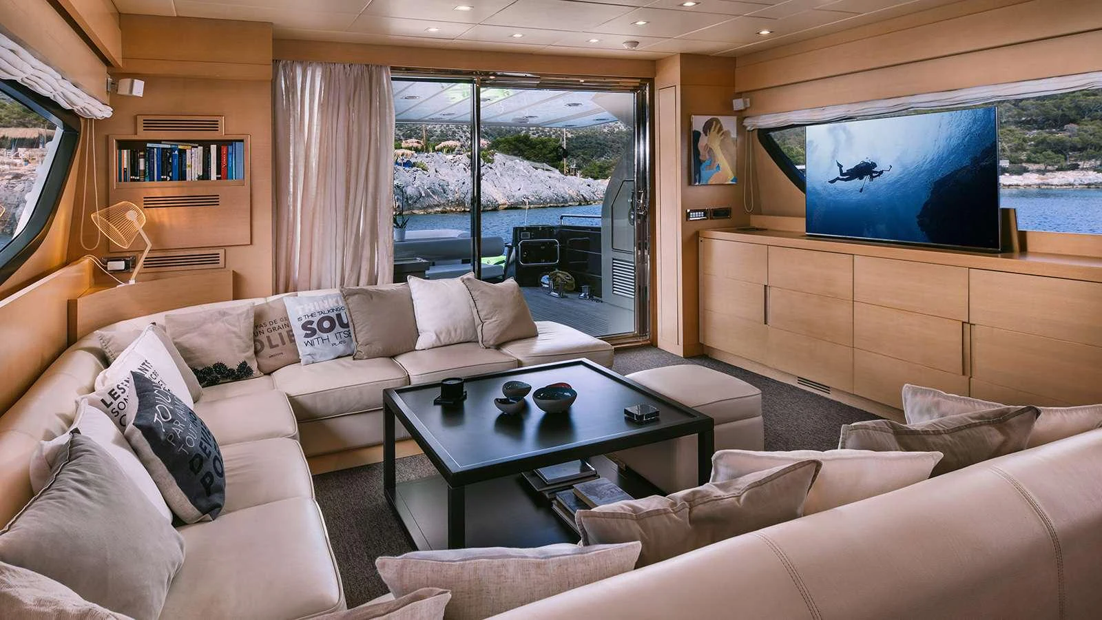 a living room with a large screen aboard SEAS THE DAY Yacht for Charter