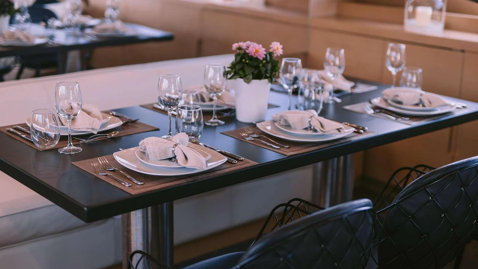 a table set with plates and glasses aboard SEAS THE DAY Yacht for Charter