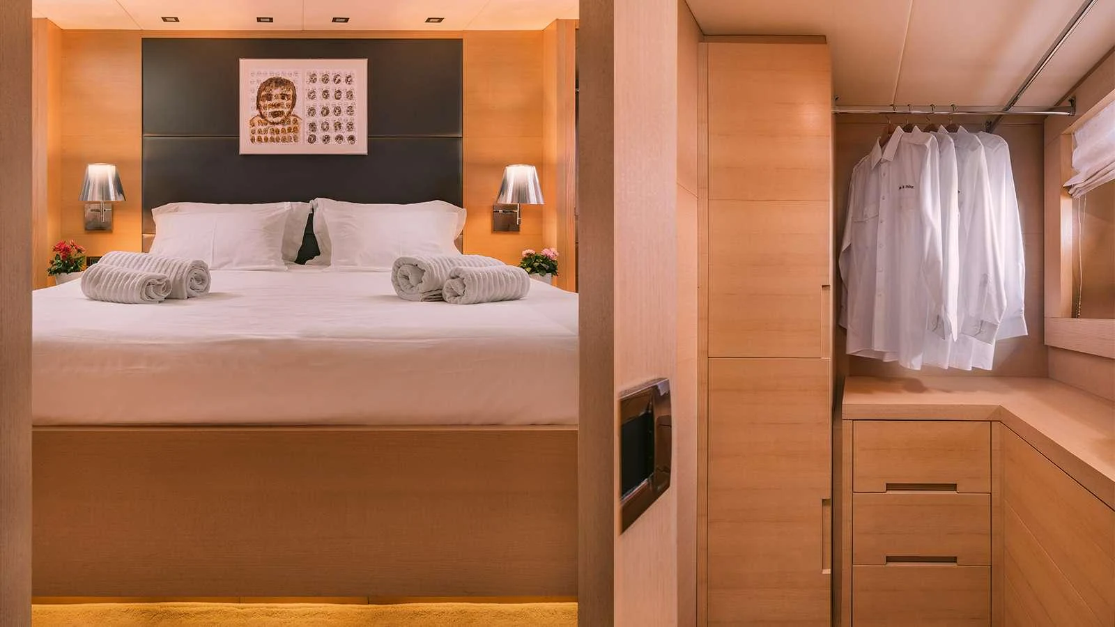 a bedroom with a bed and a dresser aboard SEAS THE DAY Yacht for Charter