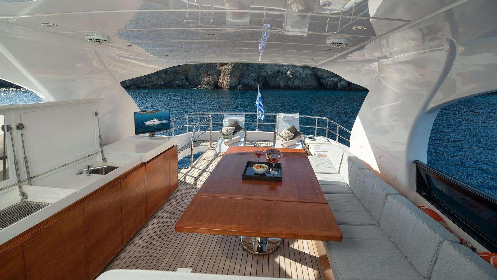 a room with a table and chairs aboard EL PECADO Yacht for Charter