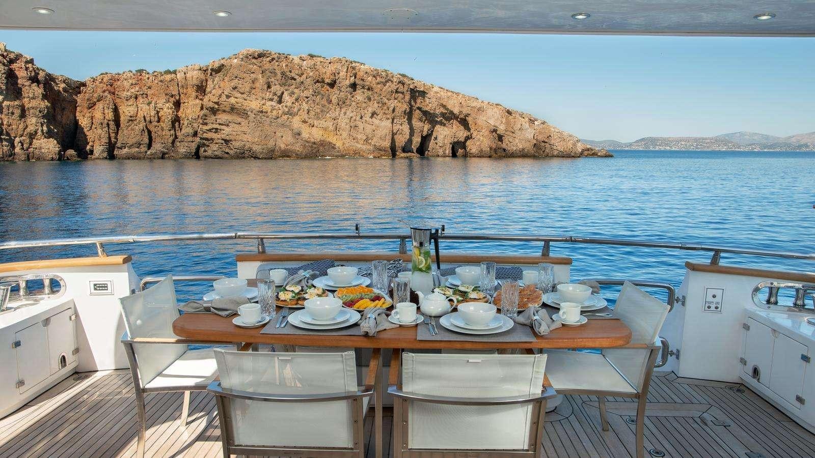 a table set for a meal on a boat aboard EL PECADO Yacht for Charter
