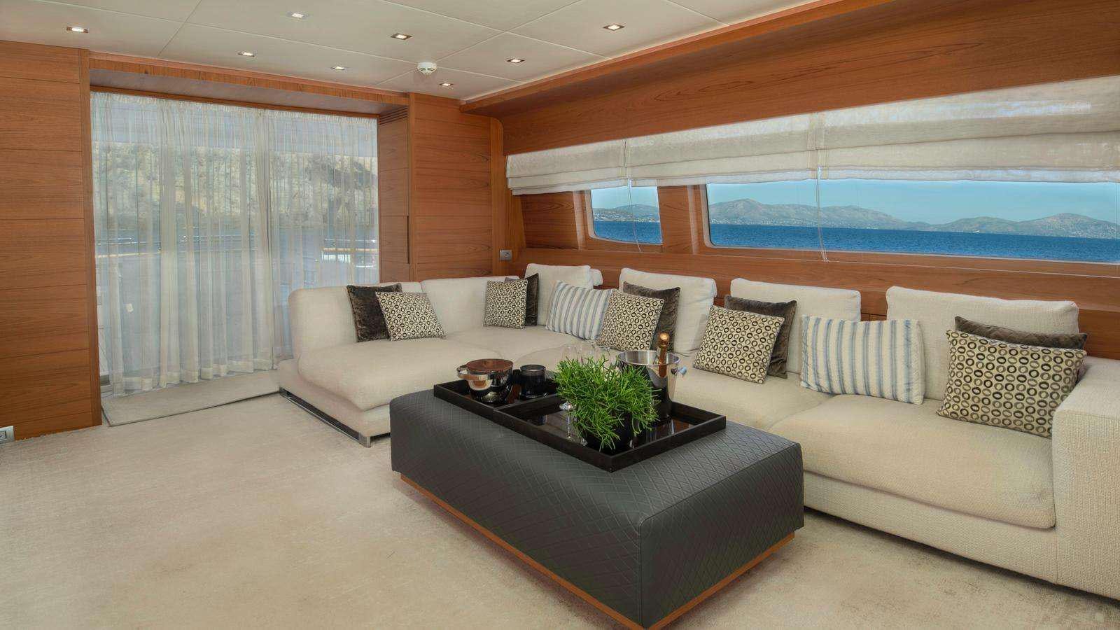a living room with a couch and a table aboard EL PECADO Yacht for Charter