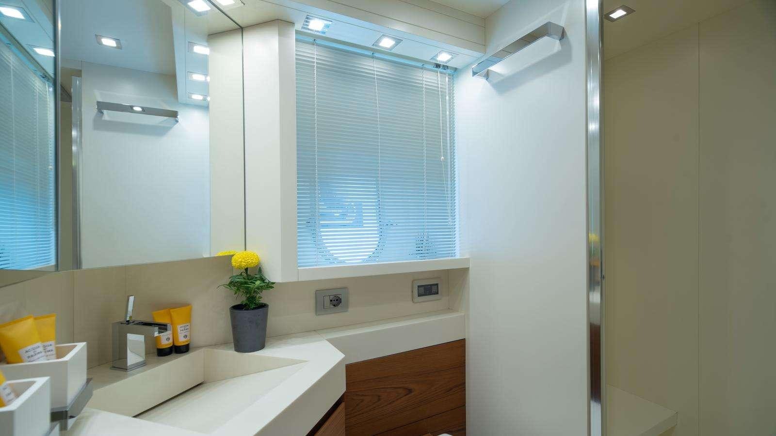 a bathroom with a countertop sink and cabinets aboard EL PECADO Yacht for Charter