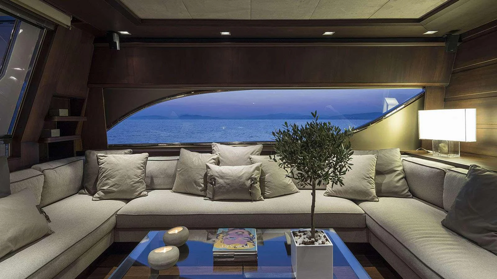 a large living room with a large blue swimming pool aboard LAZY DAYS Yacht for Charter